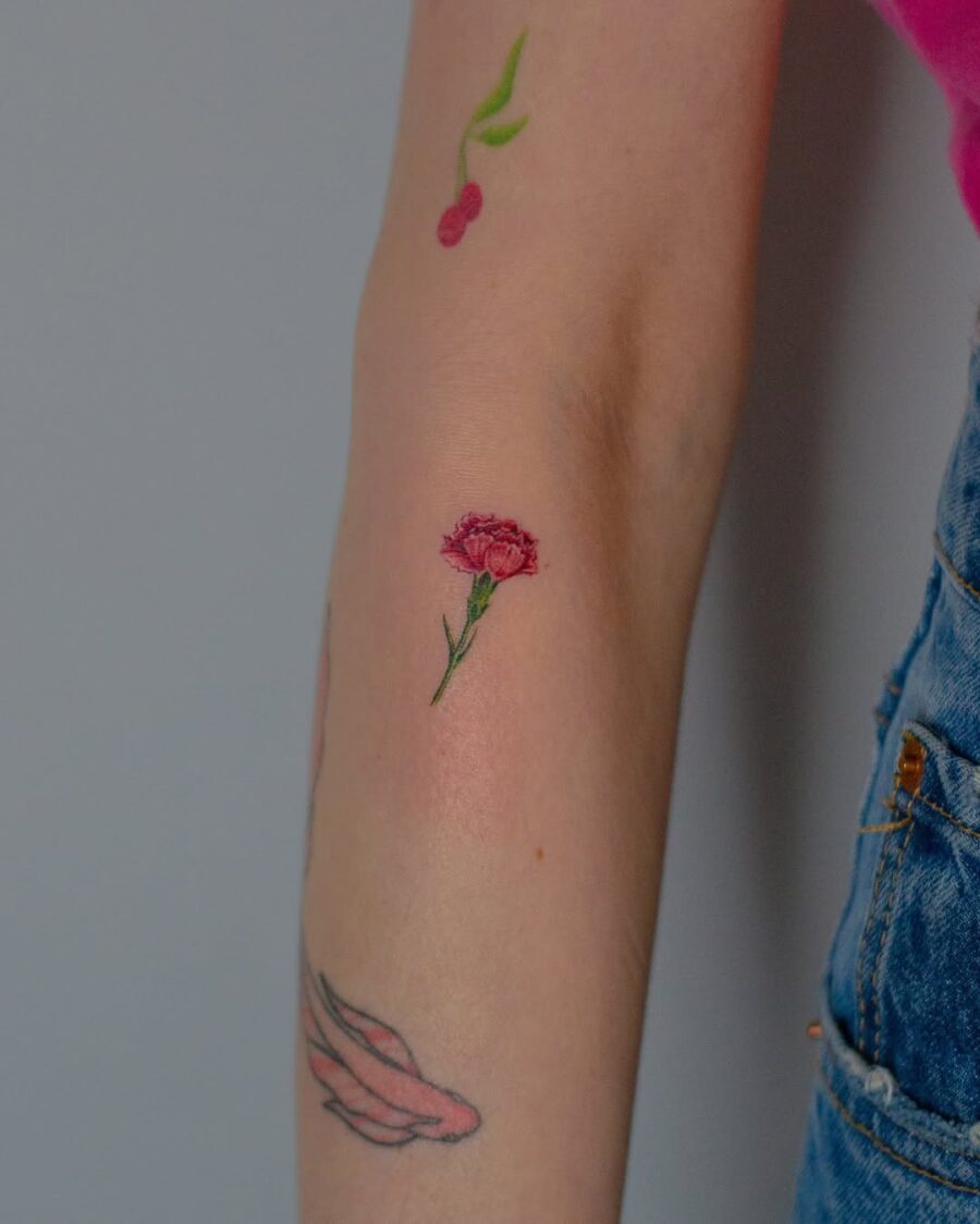 Delicate carnation tattoo with vibrant details
