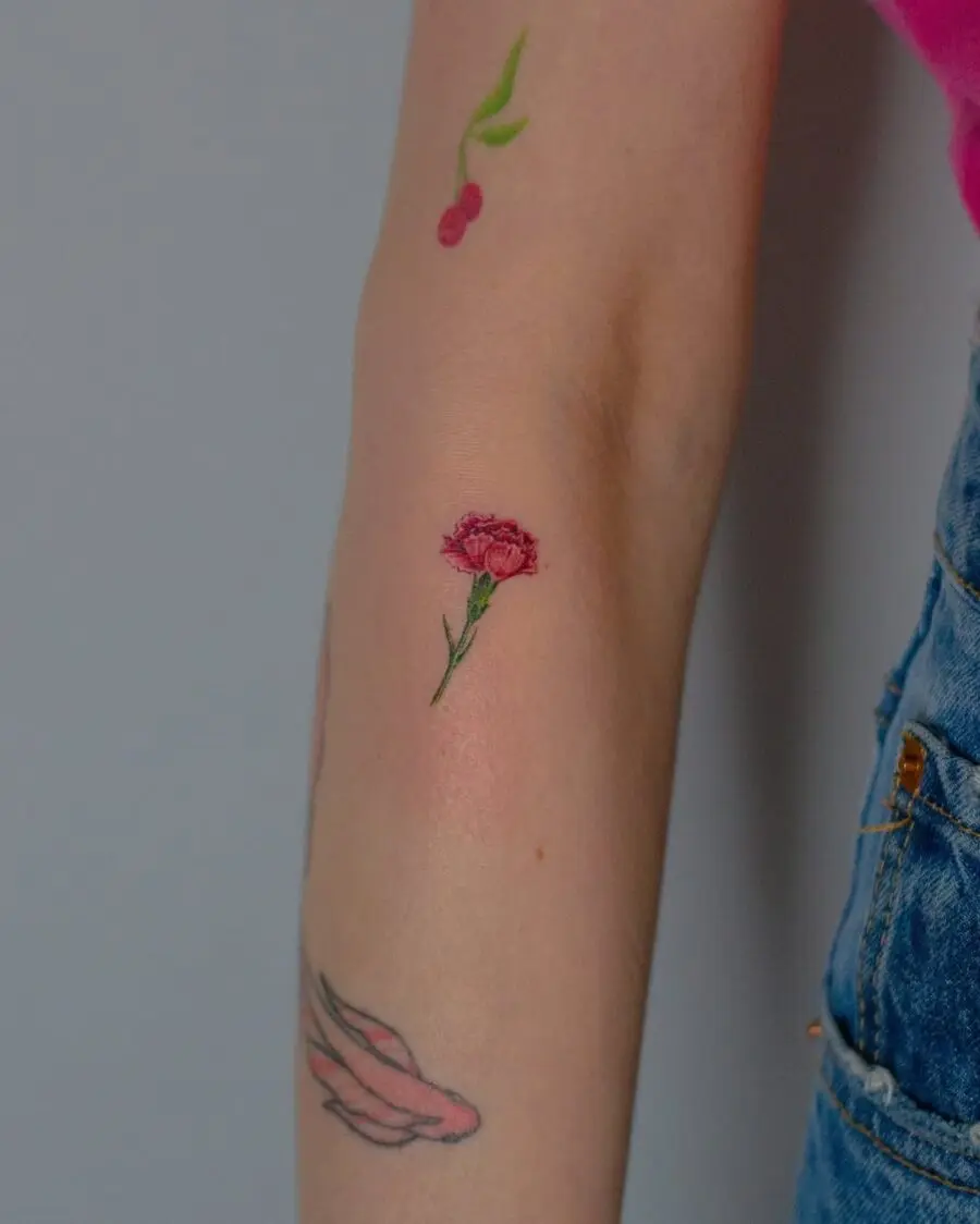 Delicate carnation tattoo with vibrant details
