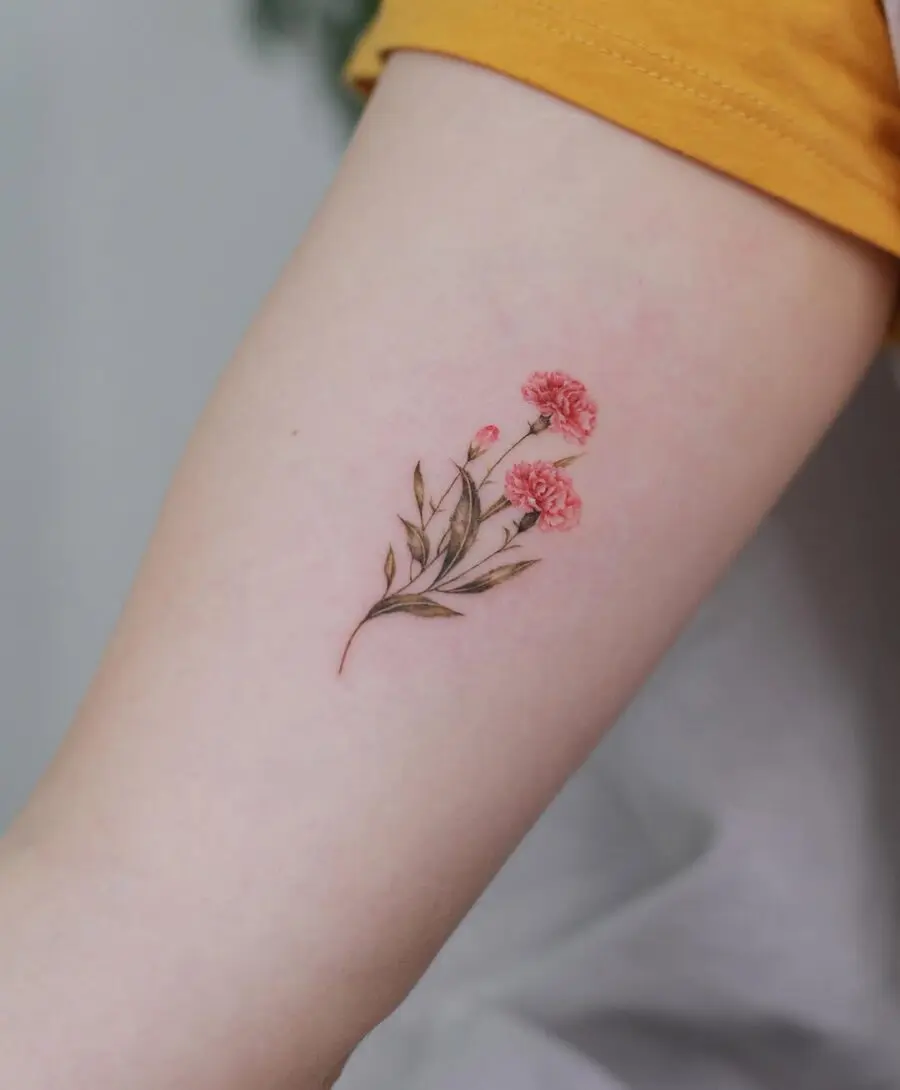 Delicate carnation tattoo on bare skin