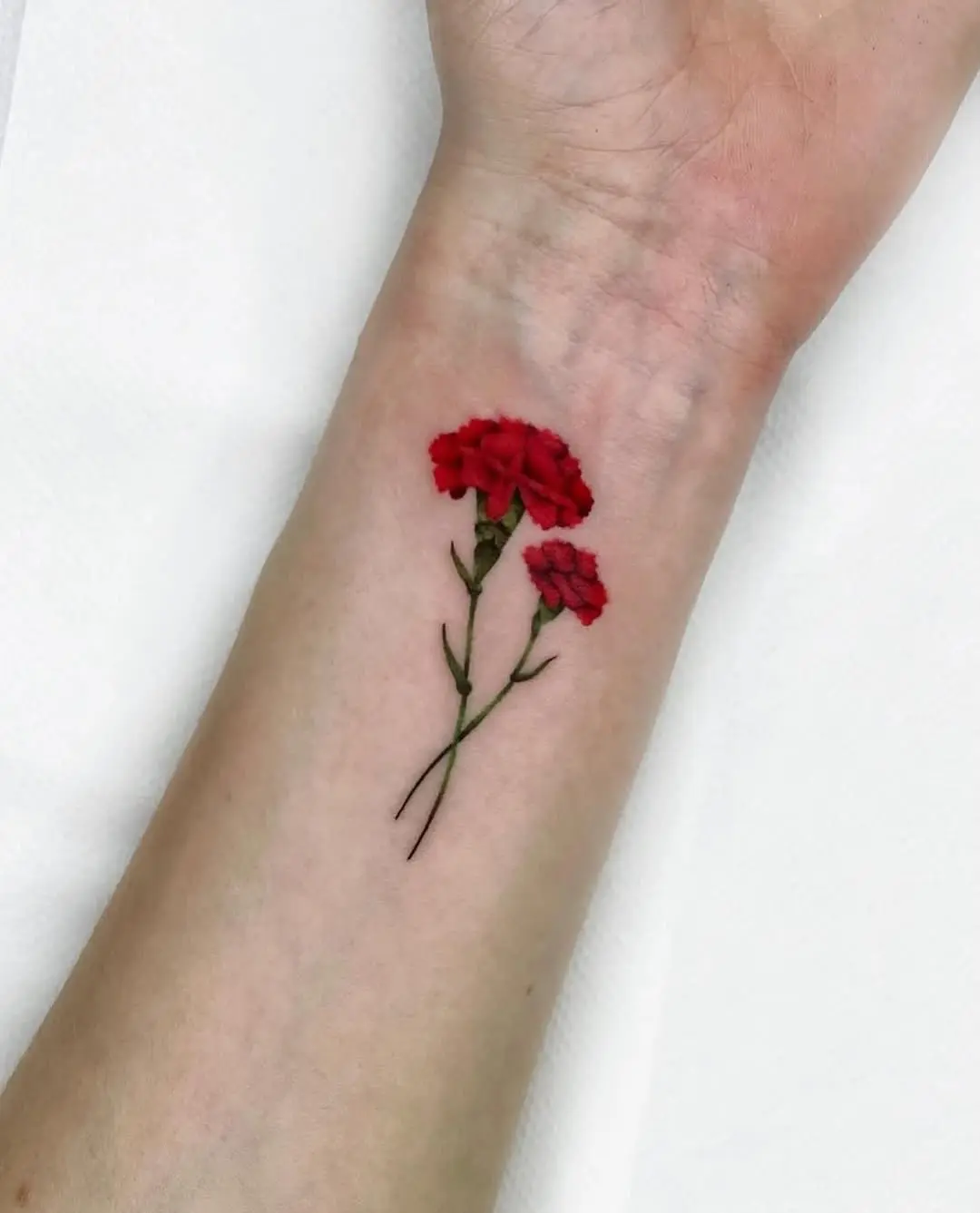 Vibrant Red Carnation Tattoo on Forearm