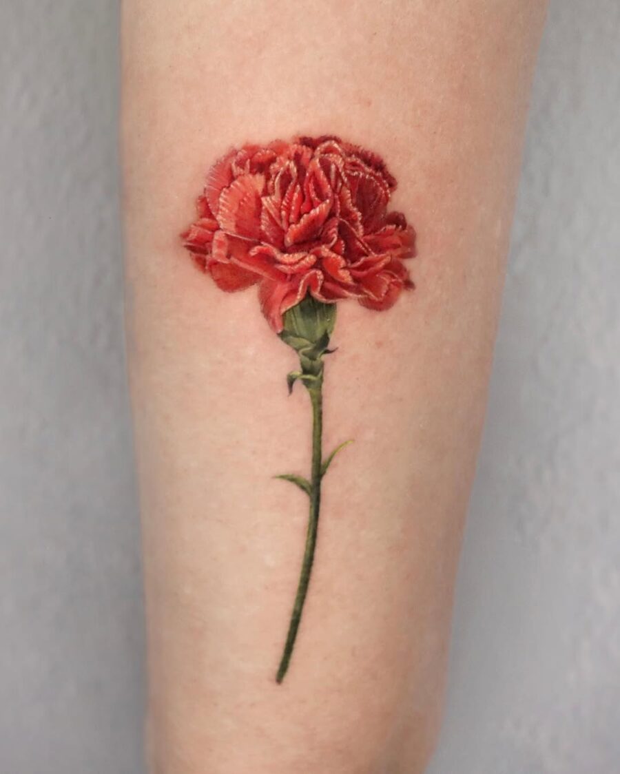 Vibrant red carnation tattoo showcasing intricate details