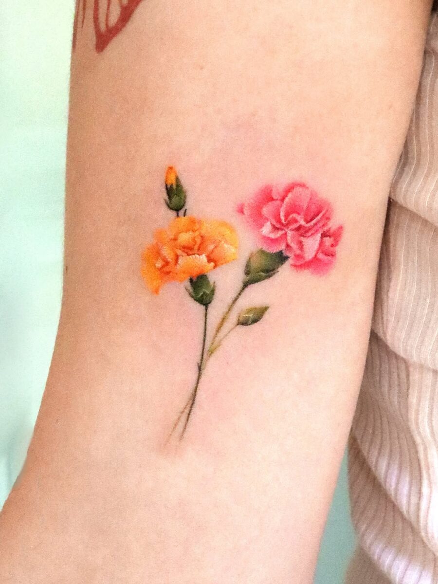 Vibrant carnation tattoo with floral elegance