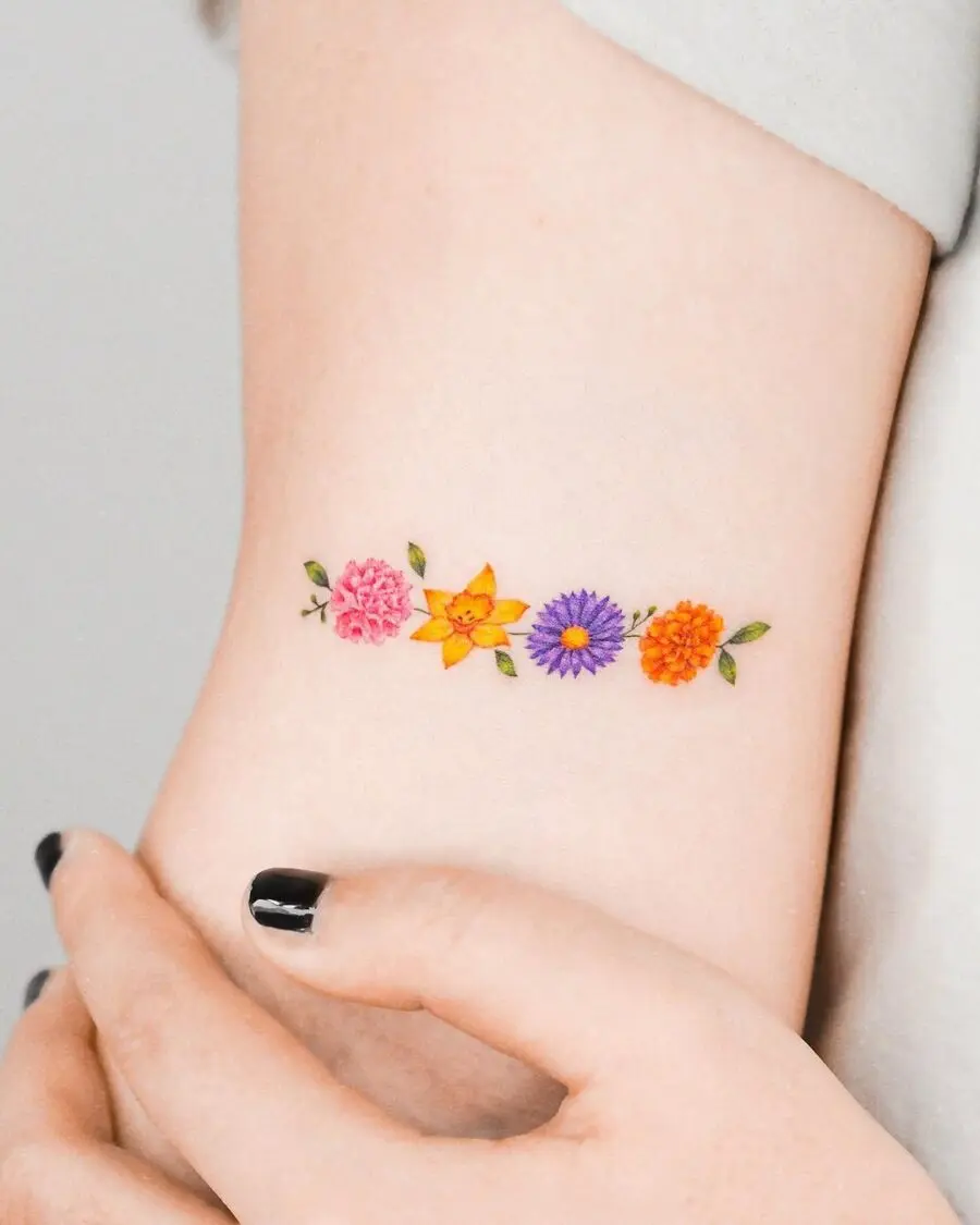 Colorful floral arrangement tattoo on inner arm