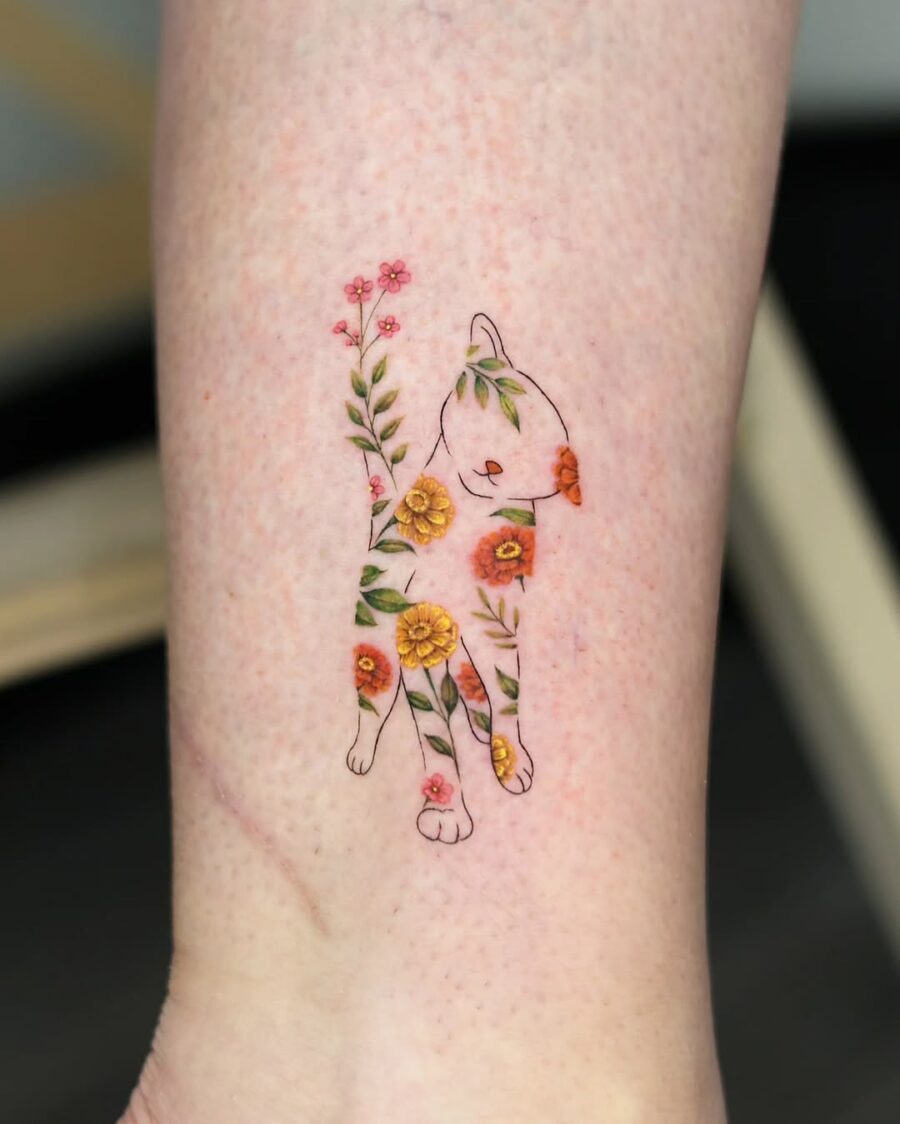 A playful cat adorned with zinnia flowers