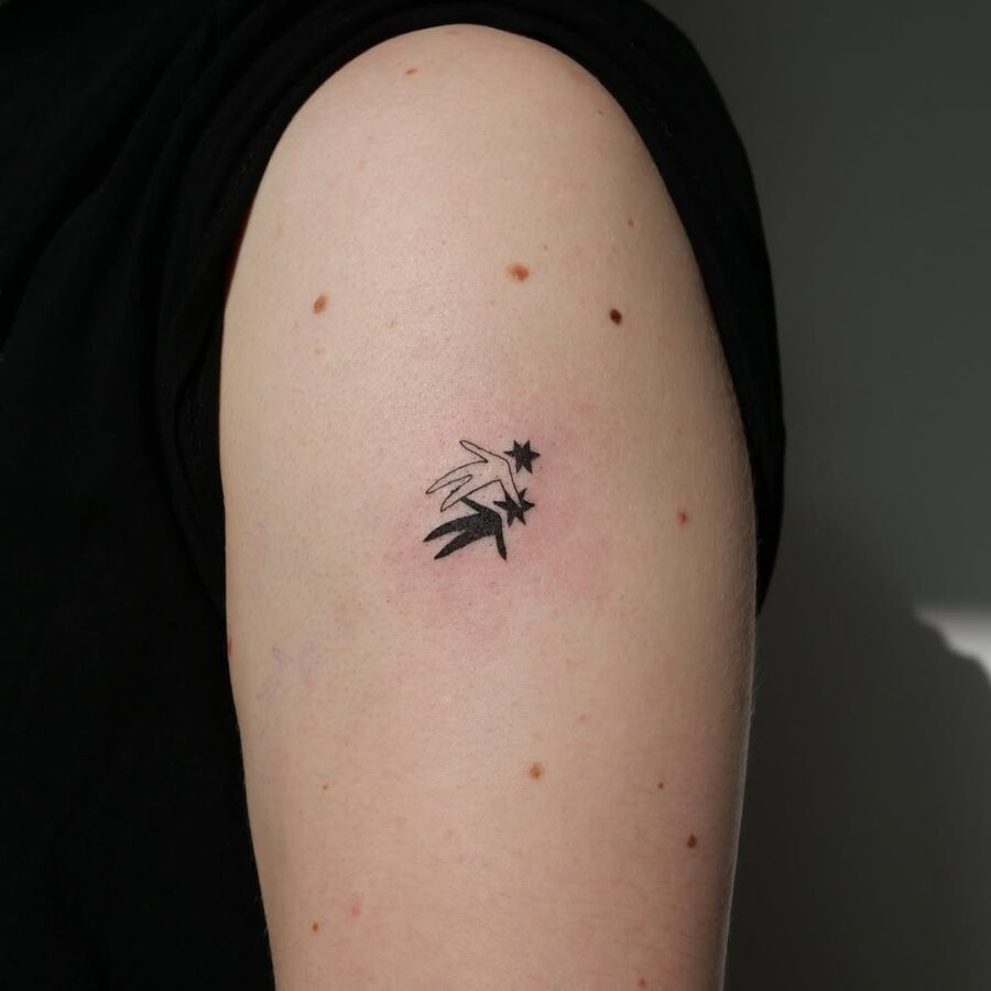 Minimalist celestial star tattoo on arm