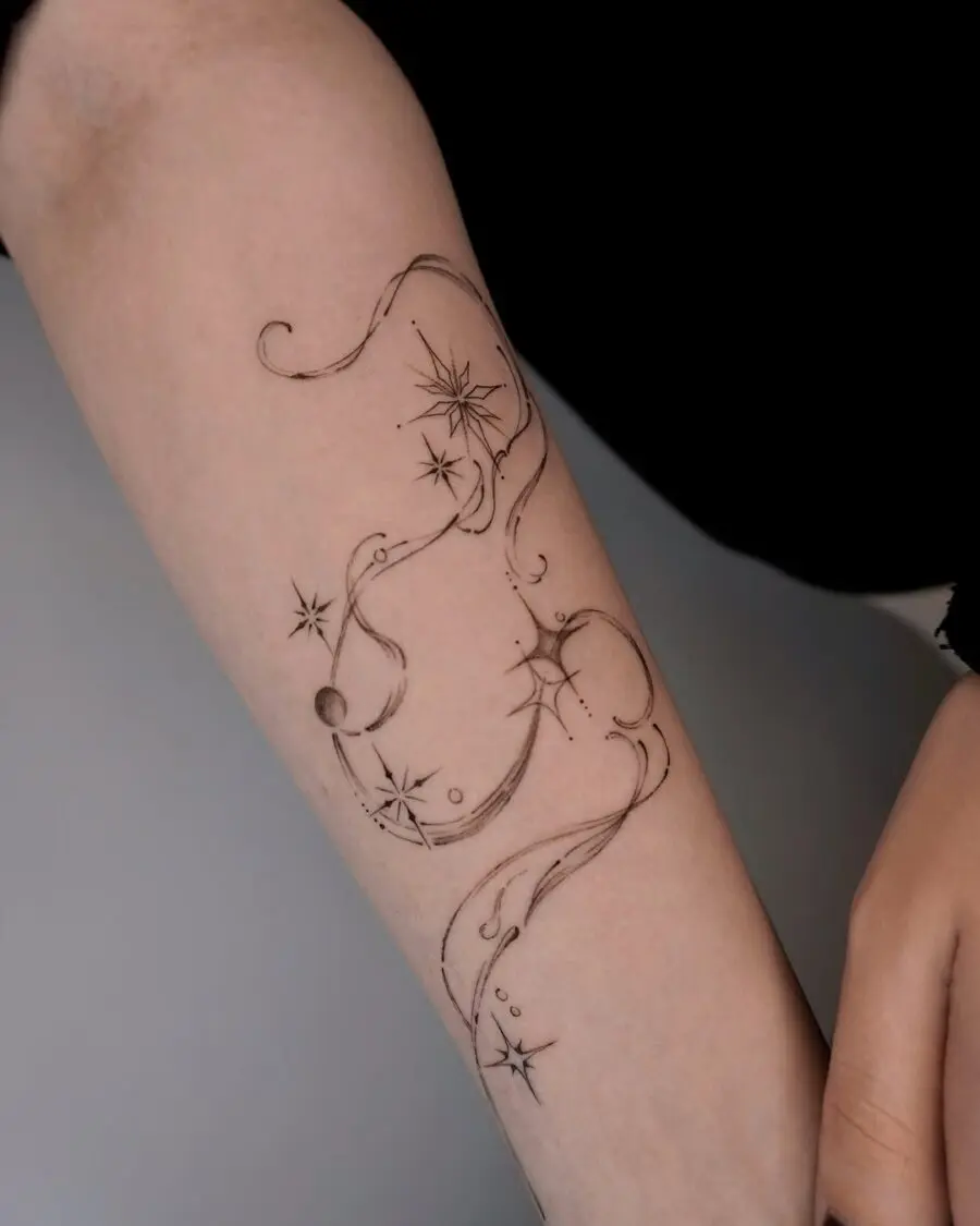 Elegant celestial tattoo with flowing lines and stars