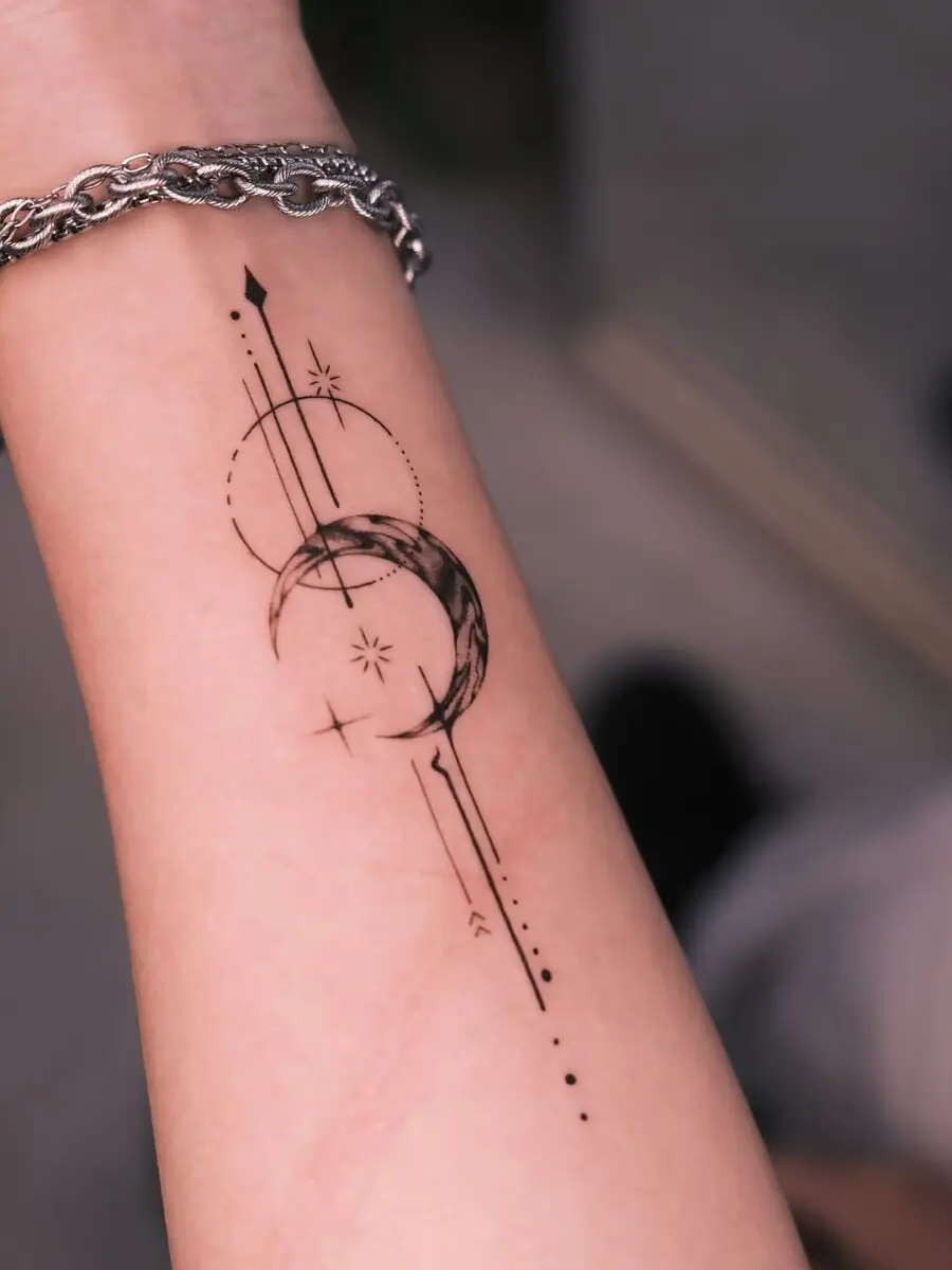 Elegant celestial tattoo featuring moon and stars