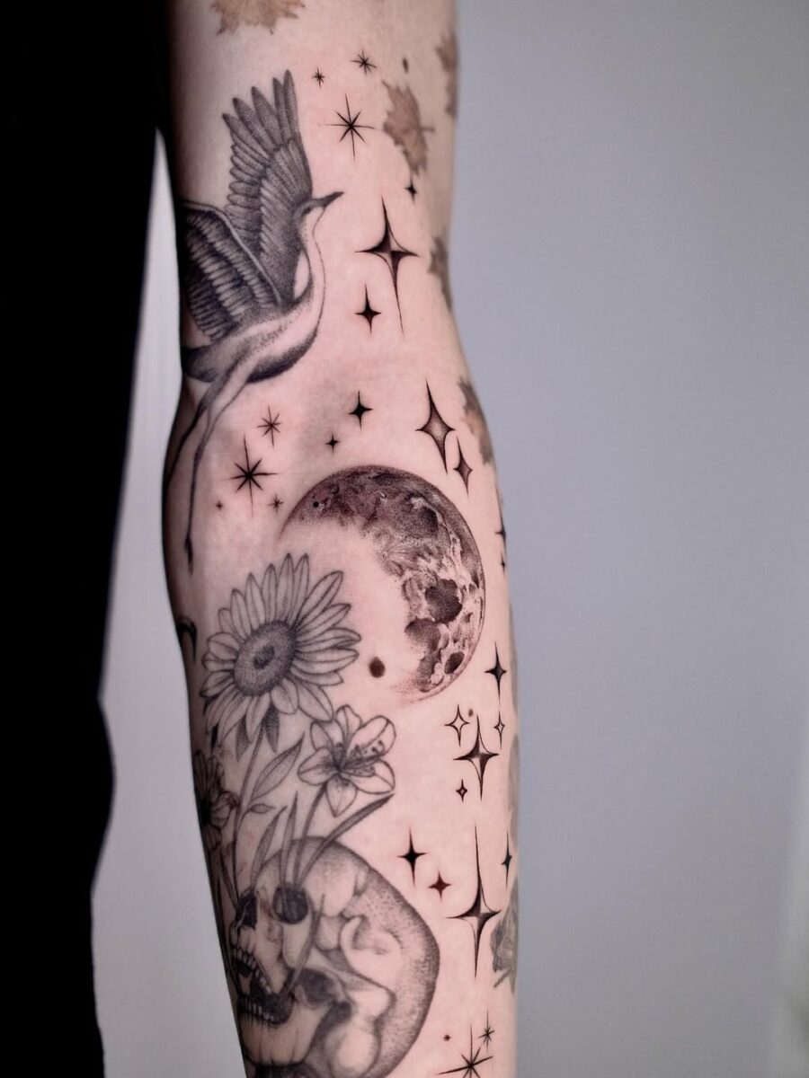 Intricate celestial tattoo with moon and flowers
