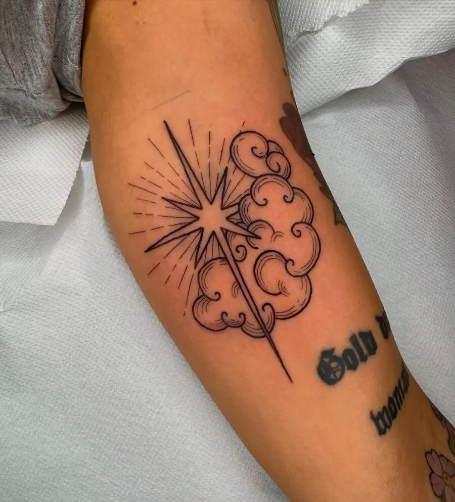 Striking star tattoo with wispy clouds