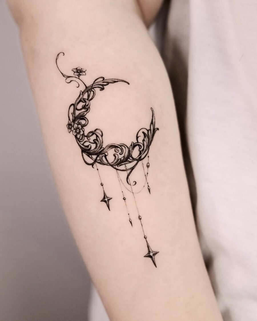 Elegant crescent moon with floral designs tattoo