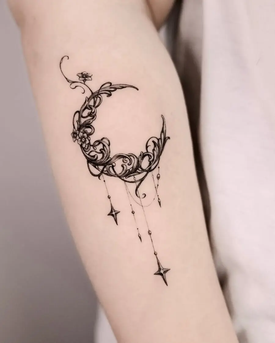 Elegant crescent moon with floral designs tattoo