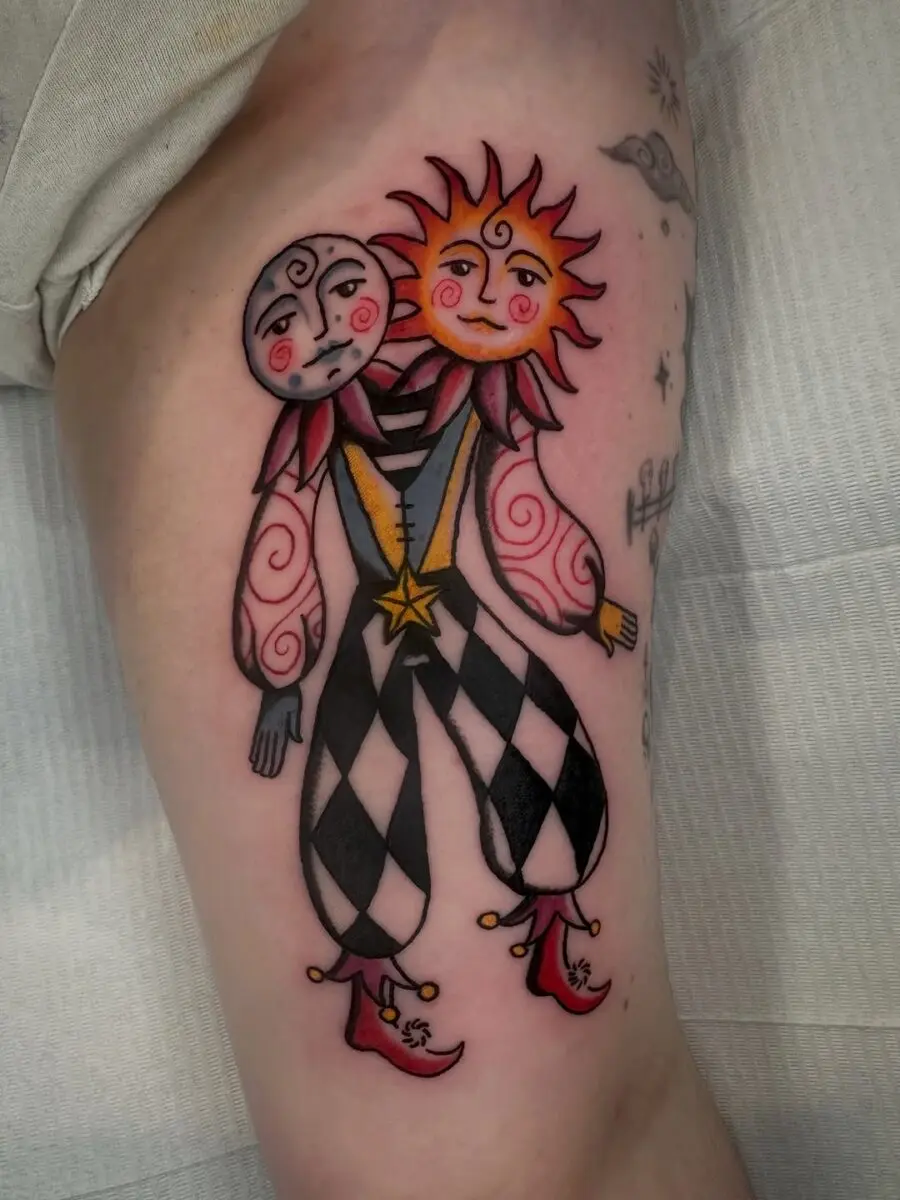 Whimsical sun and moon jester tattoo