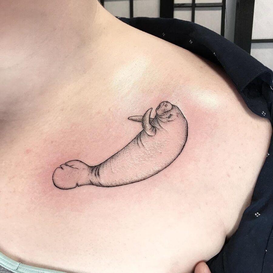 Unique manatee tattoo design on shoulder area