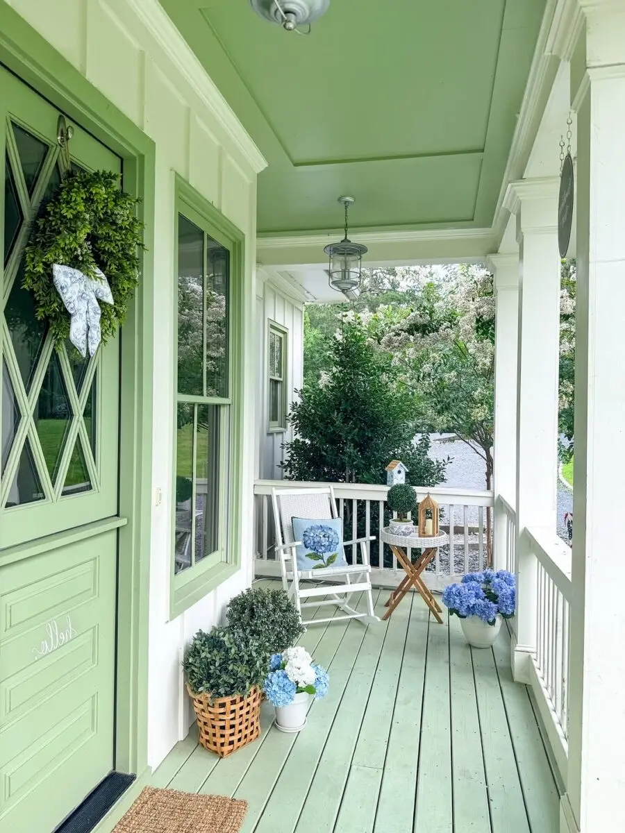 Charming porch with green accents and fresh blooms