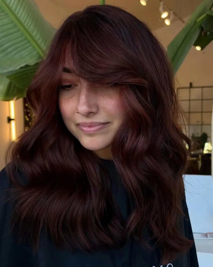 Elegant wavy hairstyle with chocolate cherry highlights