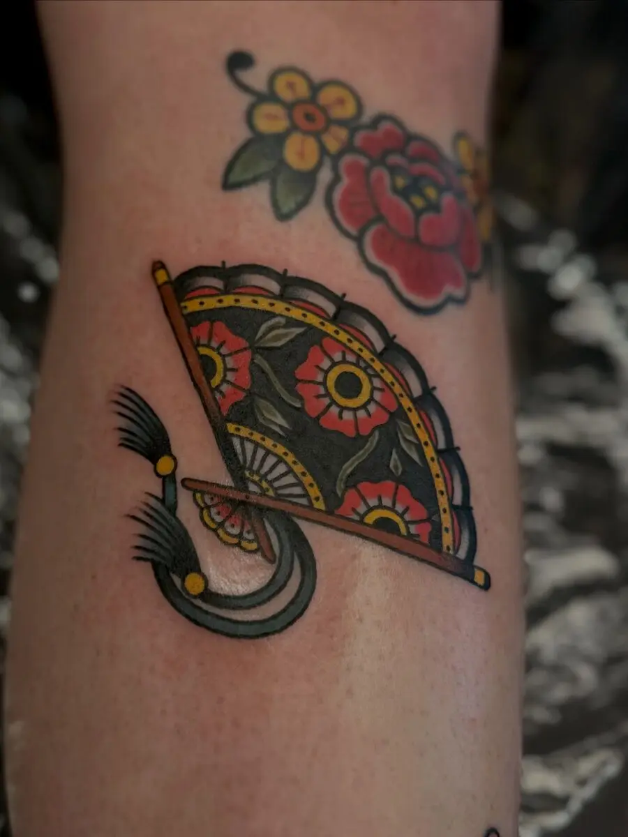 Vibrant Americana fan tattoo with floral accents