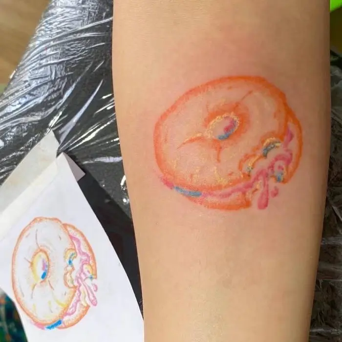 Vibrant bagel tattoo with colorful icing details