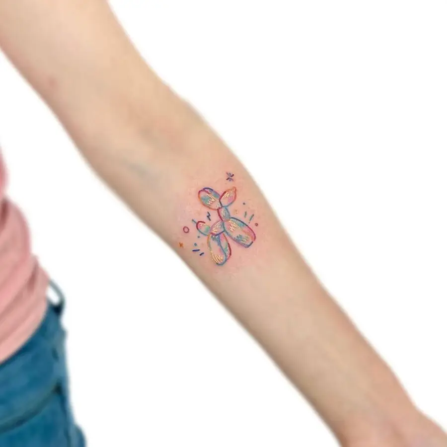 Colorful balloon dog tattoo adds playful charm