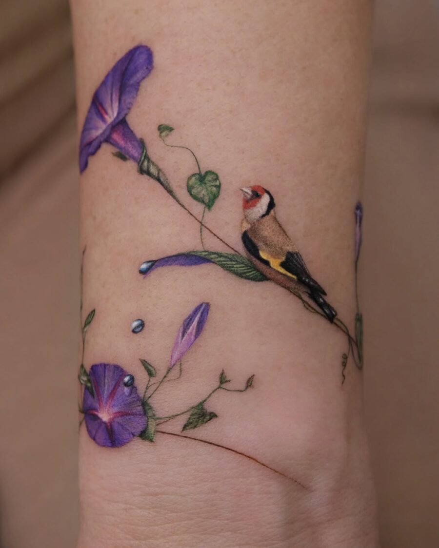 Vibrant floral and bird tattoo design