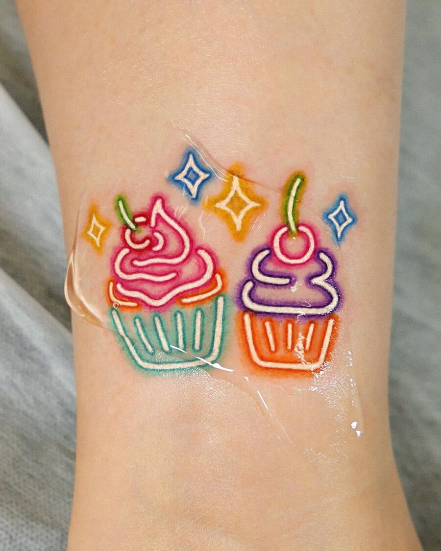 Delightful dual cupcake tattoo design