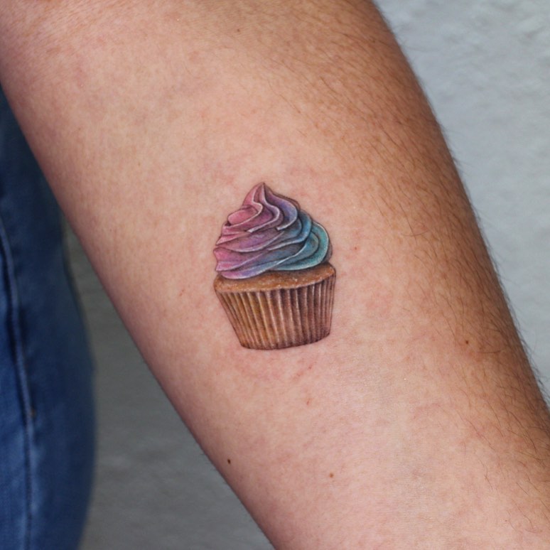 Whimsical cupcake tattoo showcasing vibrant colors