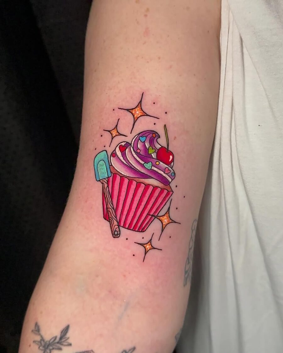 Vibrant cupcake tattoo with playful details