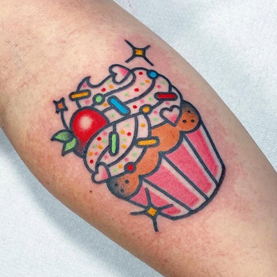 Vibrant cupake tattoo bursting with sweetness