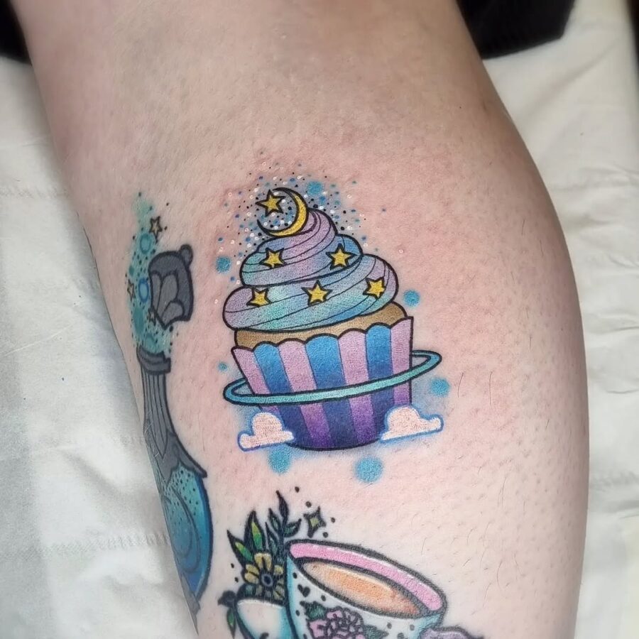 Whimsical cupcake tattoo with celestial elements