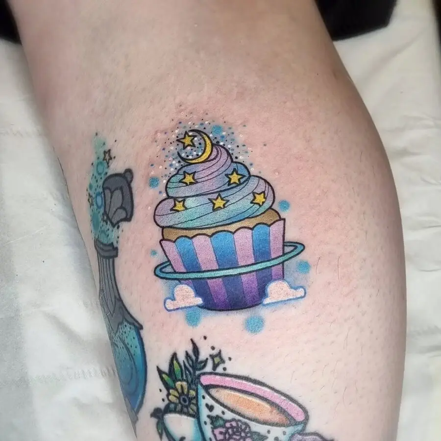 Whimsical cupcake tattoo with celestial elements