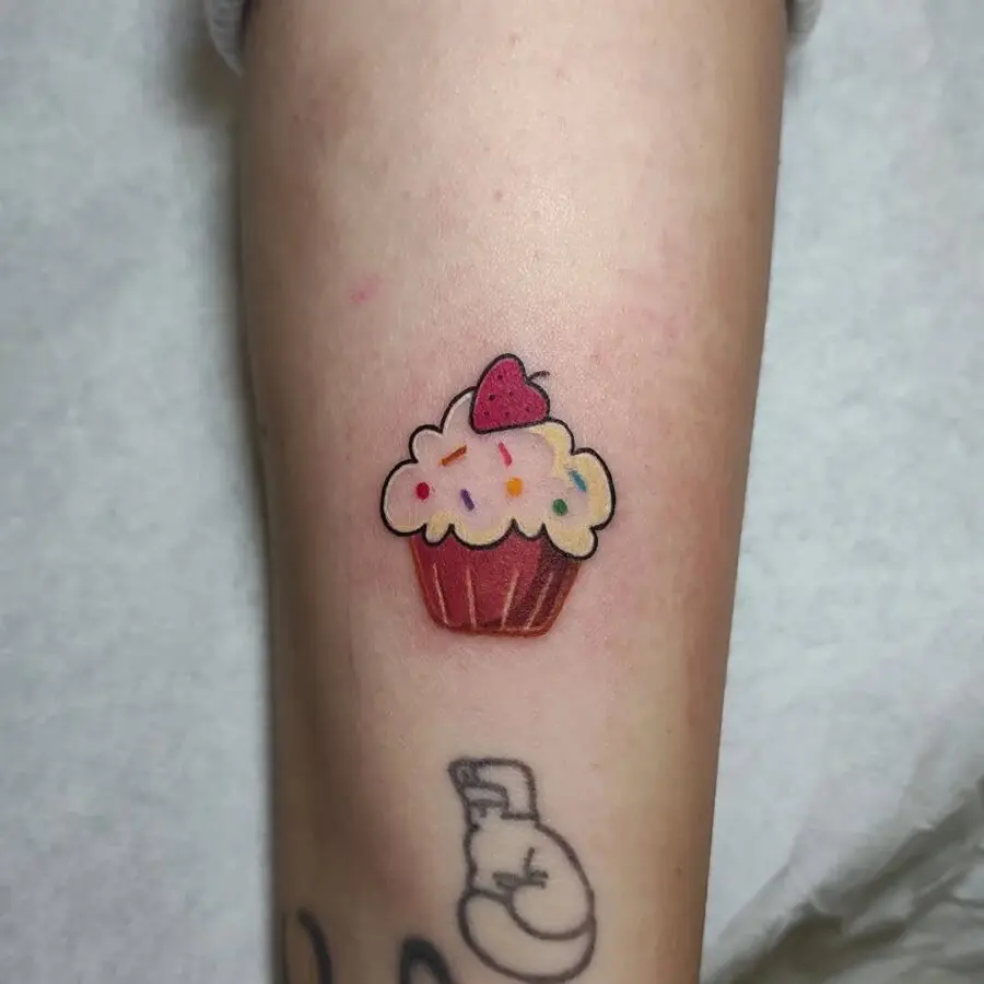 Vibrant cupcake tattoo with playful sprinkles