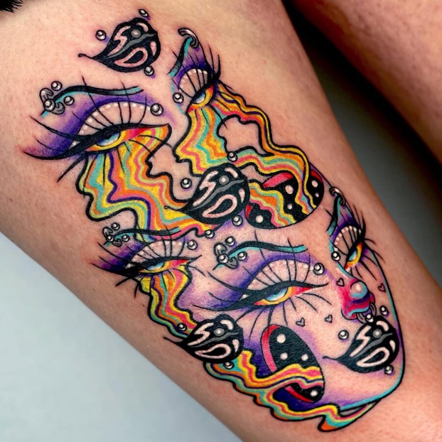 Strikingly vibrant dual-faced tattoo design