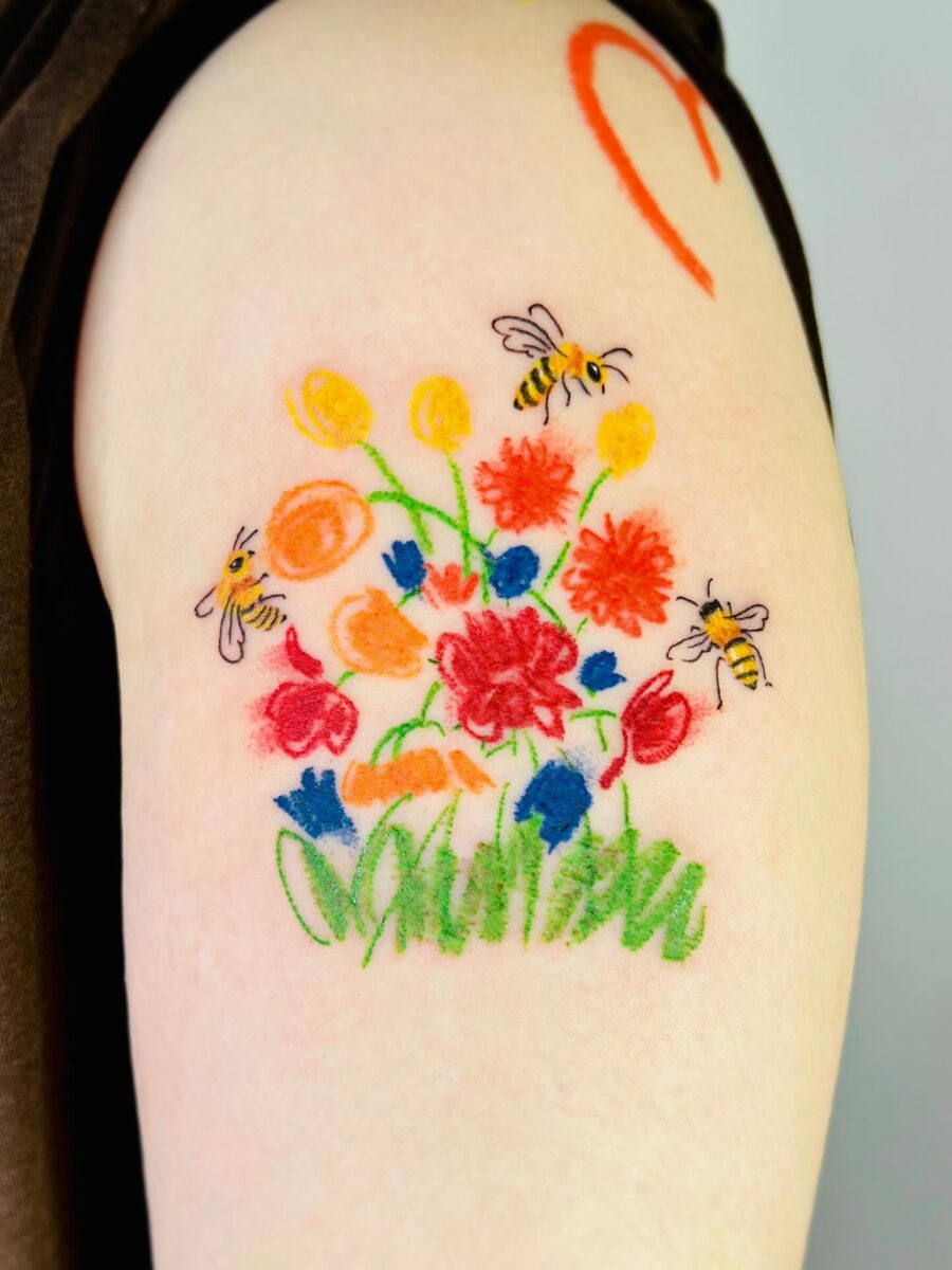 Vibrant floral tattoo with buzzing bees