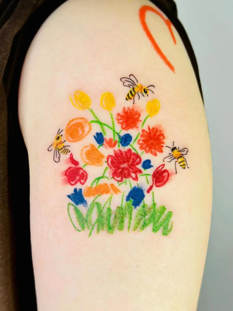 Vibrant floral tattoo with buzzing bees