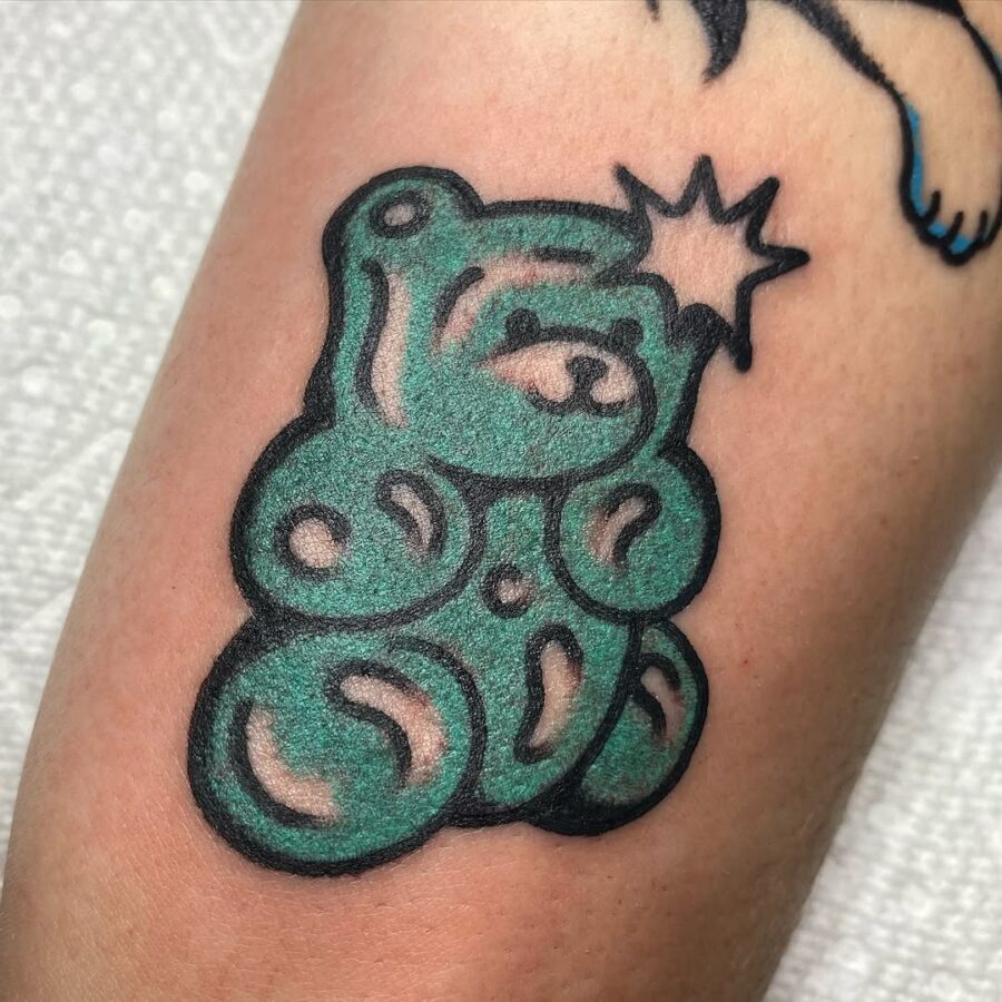 Whimsical green gummy bear tattoo design