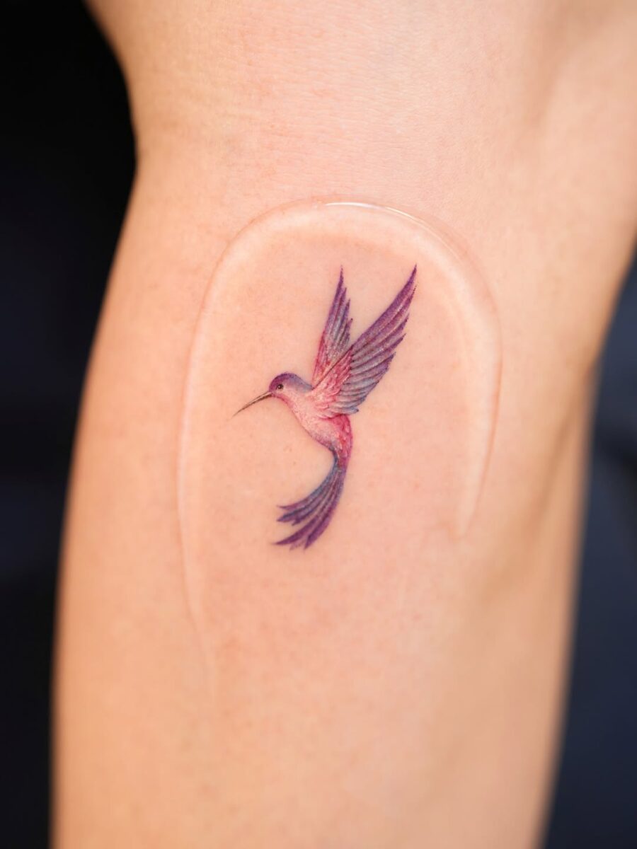 A delicate and vibrant hummingbird tattoo