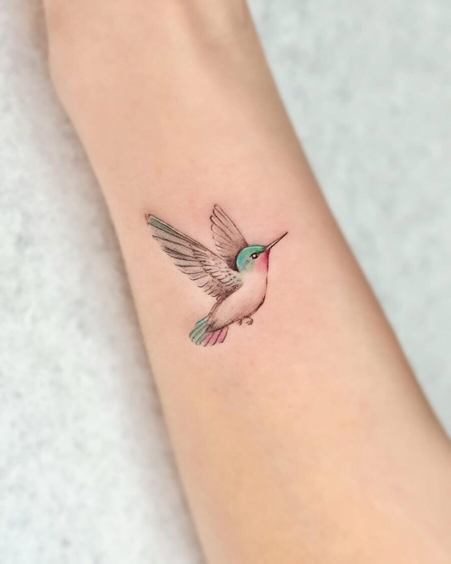 A vibrant hummingbird tattoo in flight