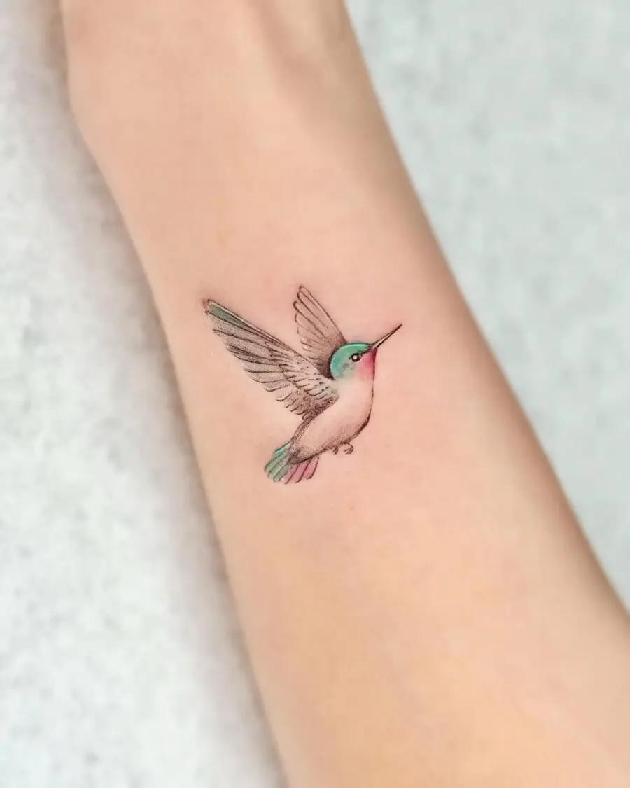 A vibrant hummingbird tattoo in flight
