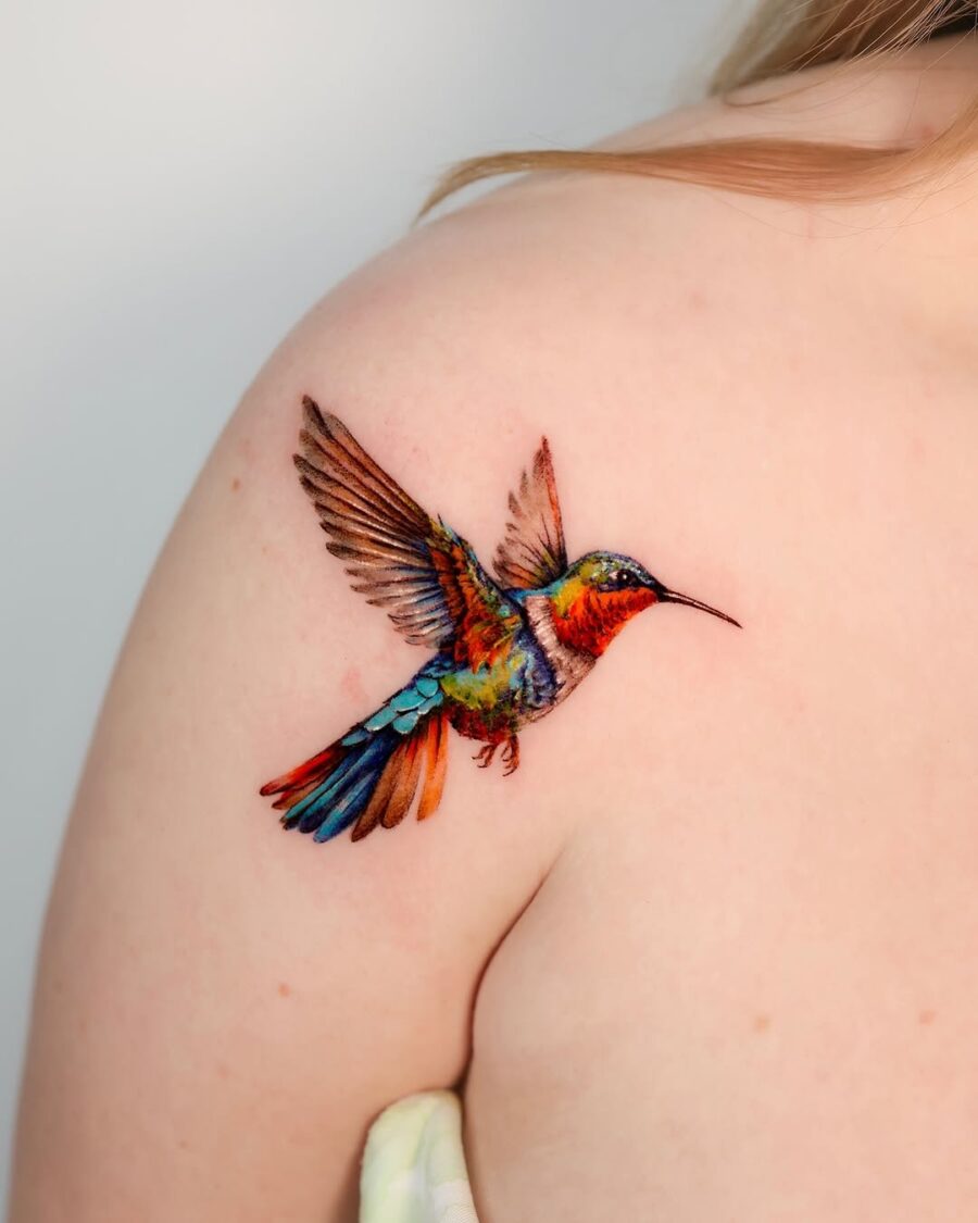 Vibrant hummingbird tattoo showcasing dynamic artistry