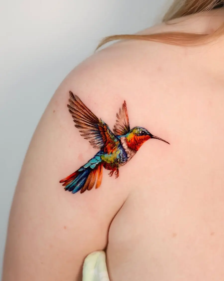 Vibrant hummingbird tattoo showcasing dynamic artistry