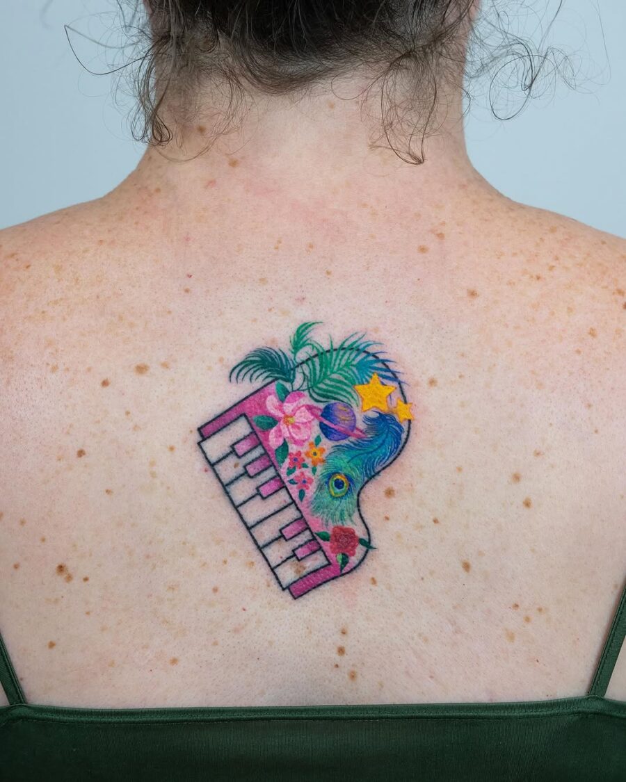 Vibrant floral piano tattoo on the back