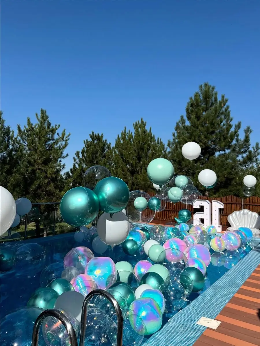 Vibrant balloons create a festive pool scene