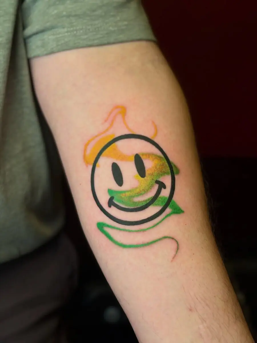 Vibrant smiley face tattoo design on display
