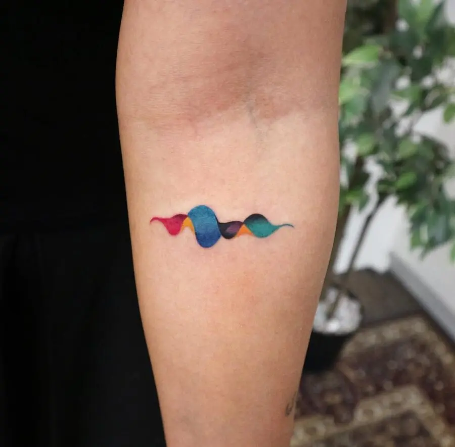 Vibrant soundwave tattoo on the forearm