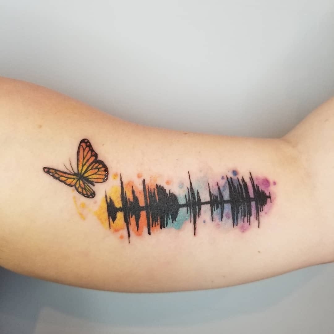 Vibrant Soundwave Tattoo with Butterfly Embellishment