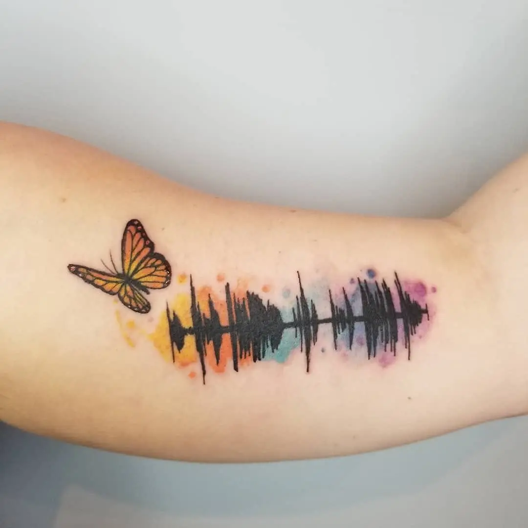 Vibrant Soundwave Tattoo with Butterfly Embellishment