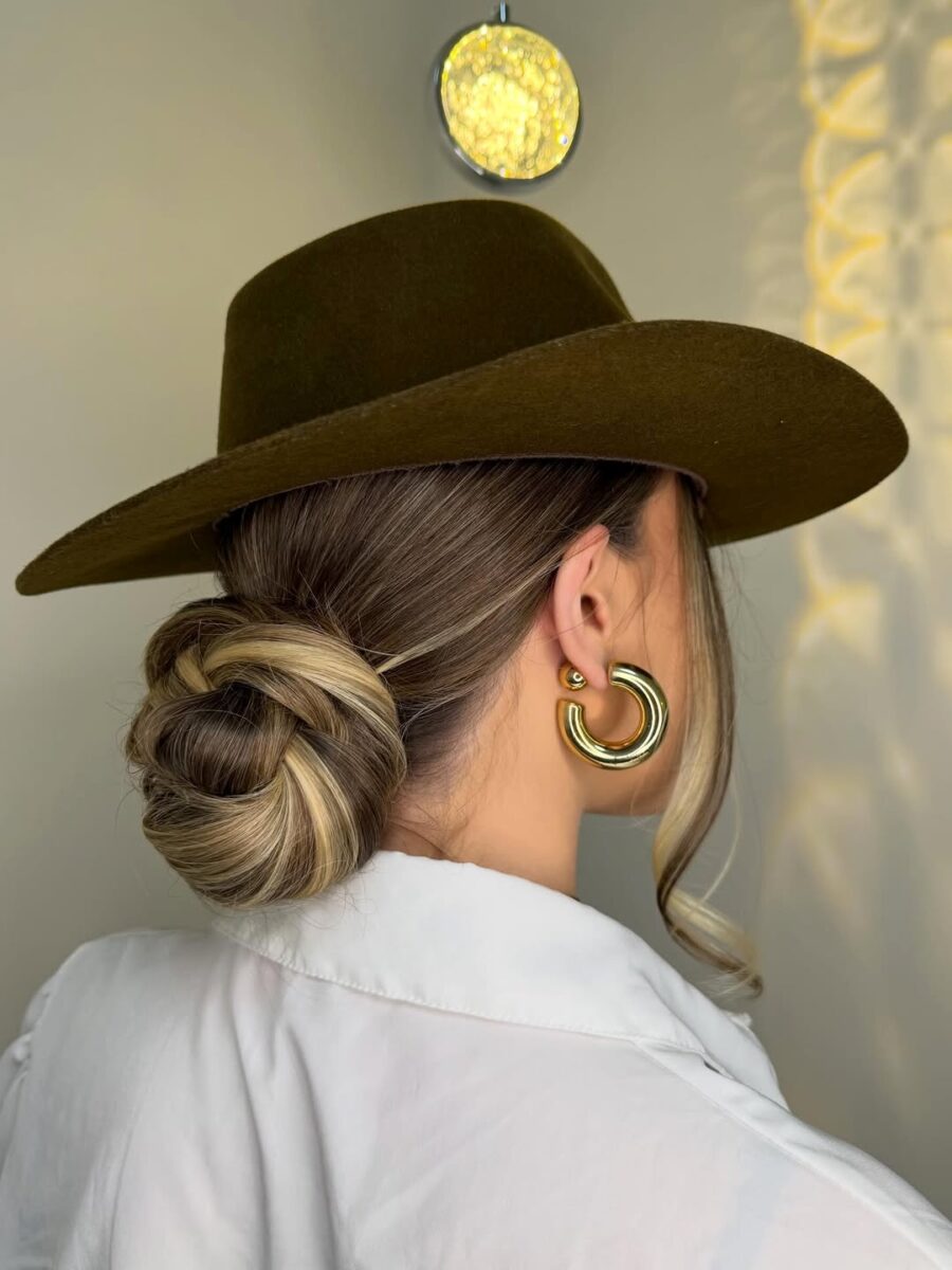 Chic bun under a stylish cowboy hat