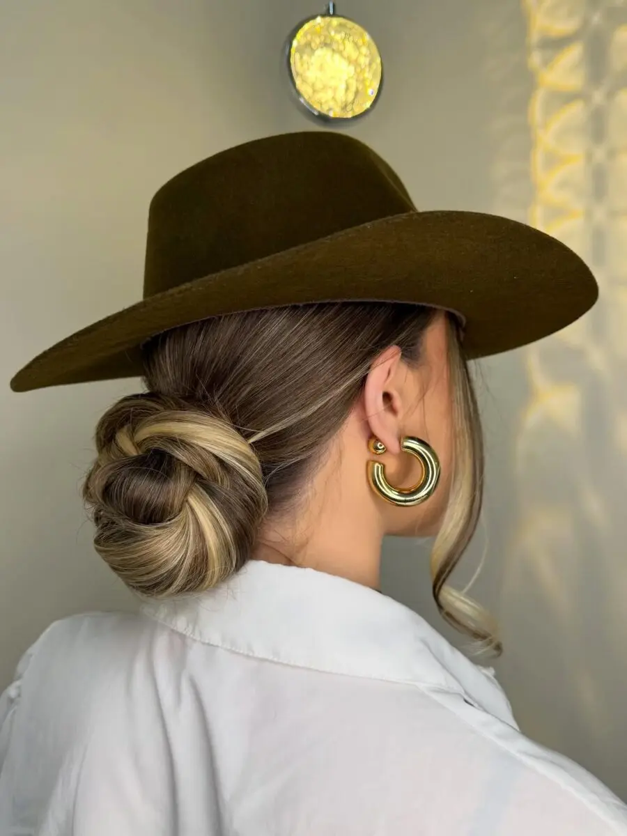 Chic bun under a stylish cowboy hat