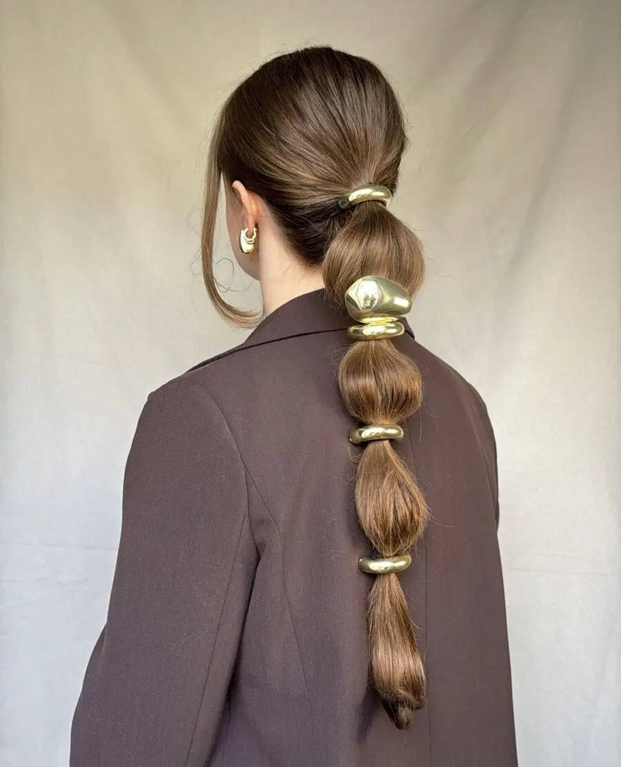 Stylish ponytail with golden hair accessories