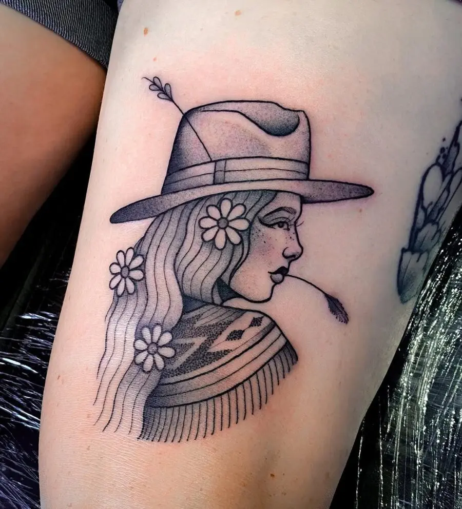 Stylish country girl tattoo with floral accents