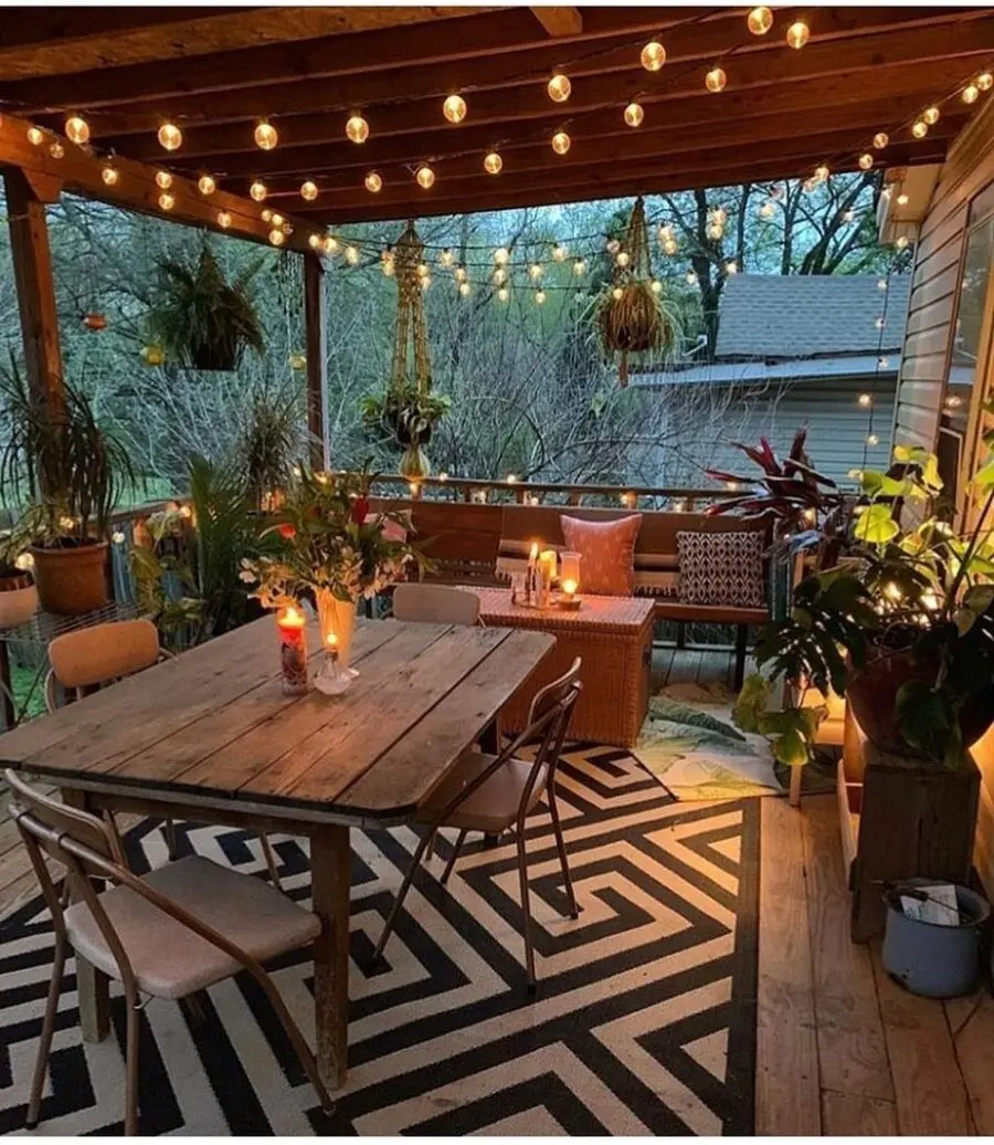 Charming porch with inviting lighting and greenery